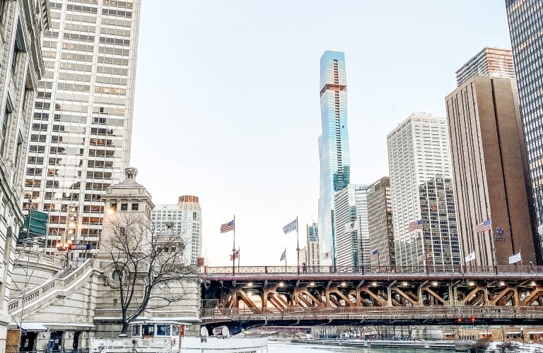 Boat and bridge with view of high rise buildings