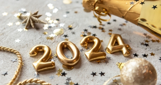 Golden color palette photo with new year 2024 numbers surrounded by confetti and decorations