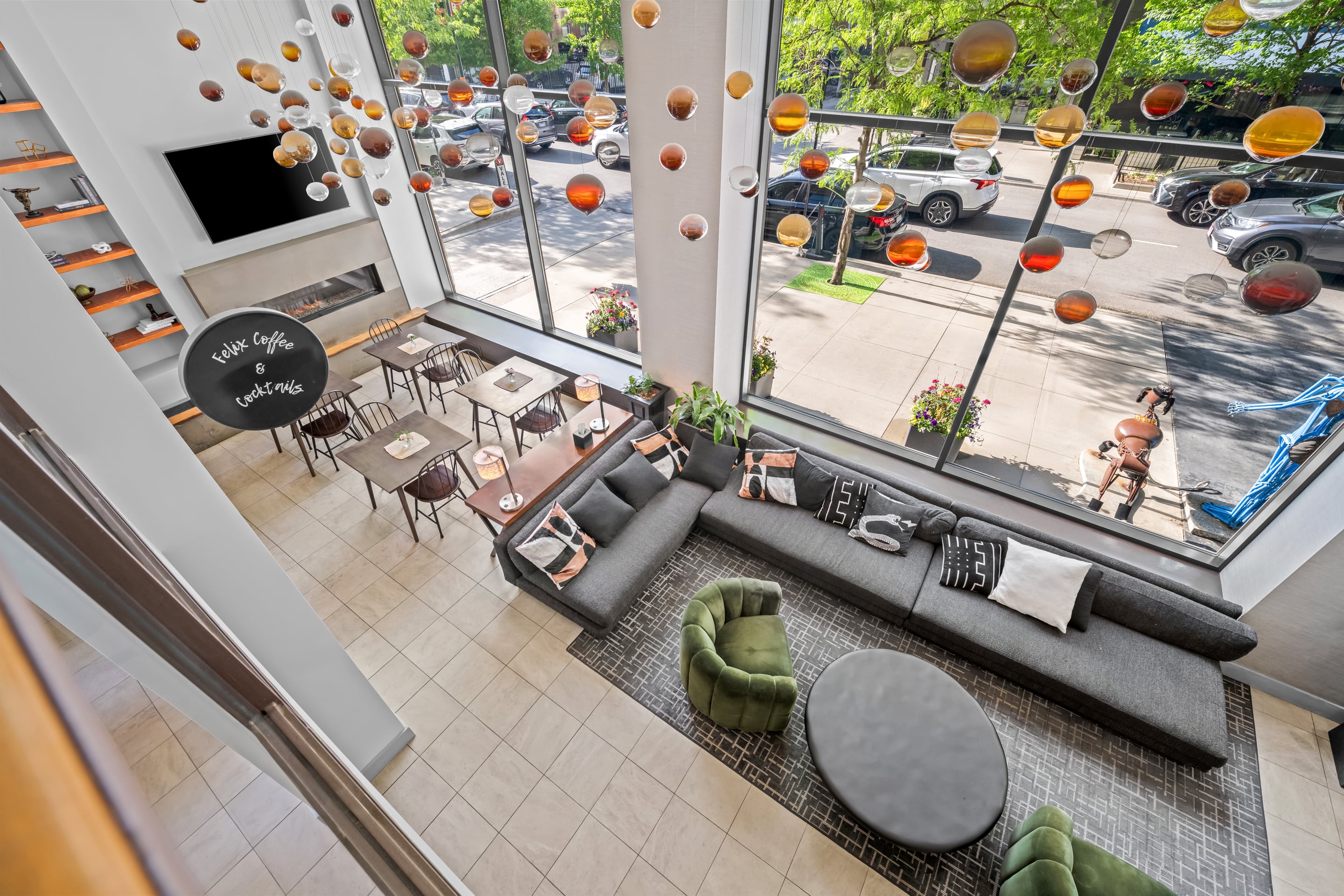 A hotel lobby with a seating area, fireplace, and large windows.